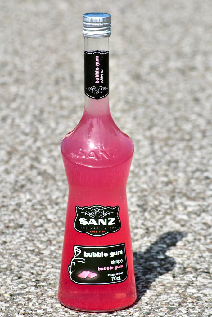 Bubble Gum Sirup Sanz 700 ml in einer pinkfarbenen Flasche mit schwarzem Etikett auf hellem Untergrund.