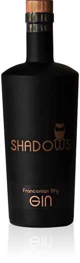 Flasche Shadows Franconian Dry Gin in mattschwarzem Design mit kupferfarbenen Akzenten vor weißem Hintergrund.